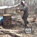 man pouring cooking oil at bear bait station