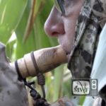 woman blowing into a goose call