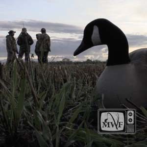 group of people with goose decoy in the foreground